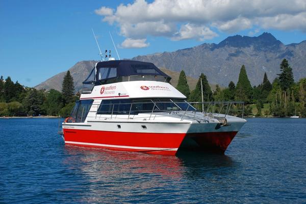 Southern Discoveries' Queenstown Lake Cruise on Lake Wakatipu with The Remarkables in the background.